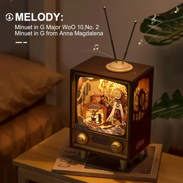 3D wooden circus music box resembling a vintage TV, lit with carnival scene inside.