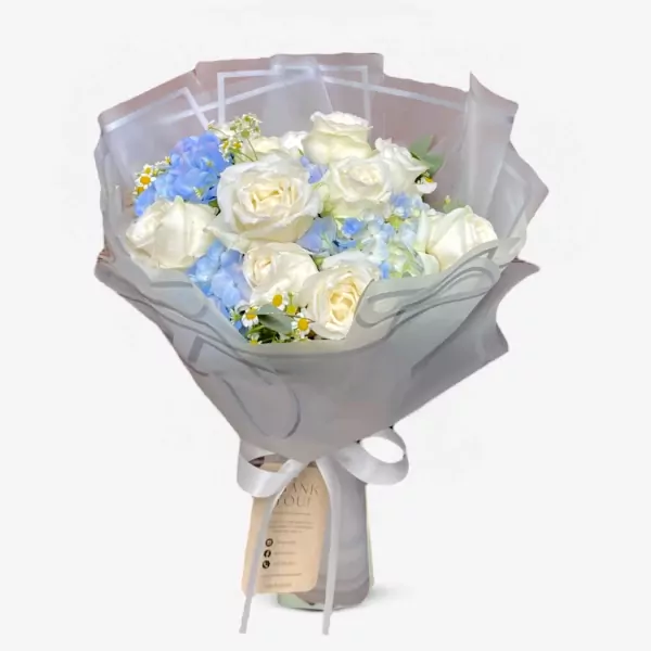 Bouquet of white roses and blue hydrangeas with daisies, wrapped in gray paper and tied with a white ribbon.