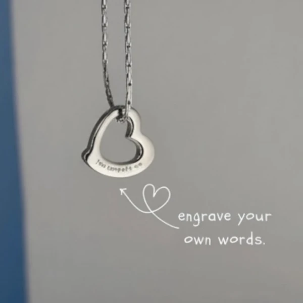 Silver heart pendant necklace with "engrave your own words" text and a heart graphic.
