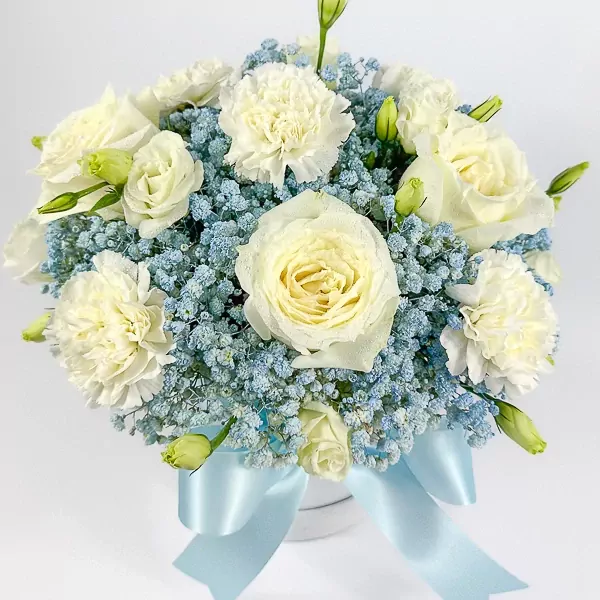 White roses and carnations with blue gypsophila in a white box with a light blue ribbon.