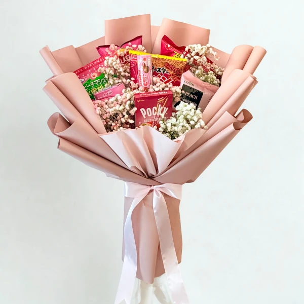 Pink snack bouquet with Pocky, Japanese chips, and baby's breath flowers.