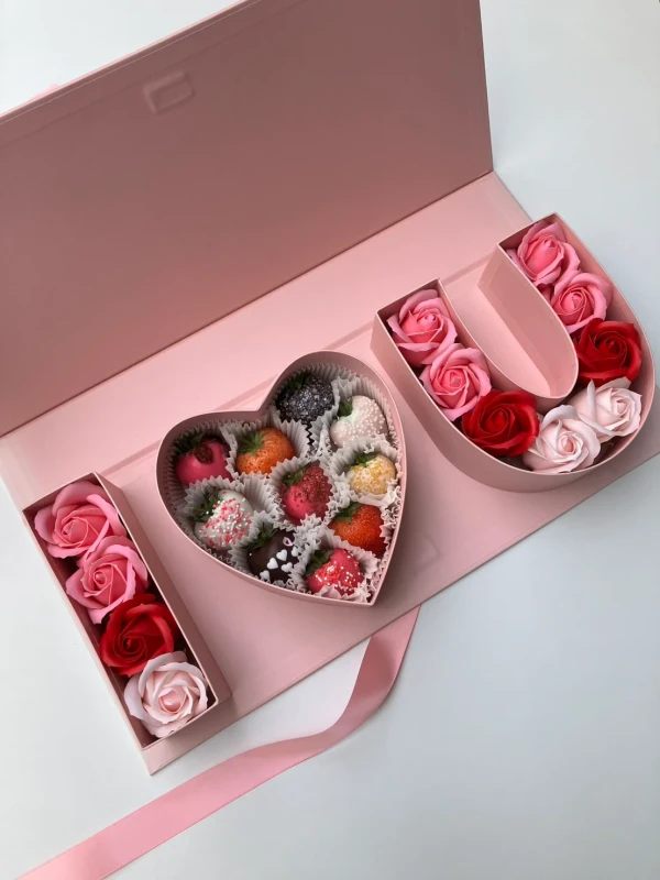 Pink gift box with "I Love You" spelled out in chocolate strawberries and faux roses.