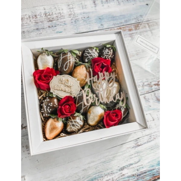 Chocolate-dipped strawberries and red roses in a white gift box with "Happy Birthday" topper.