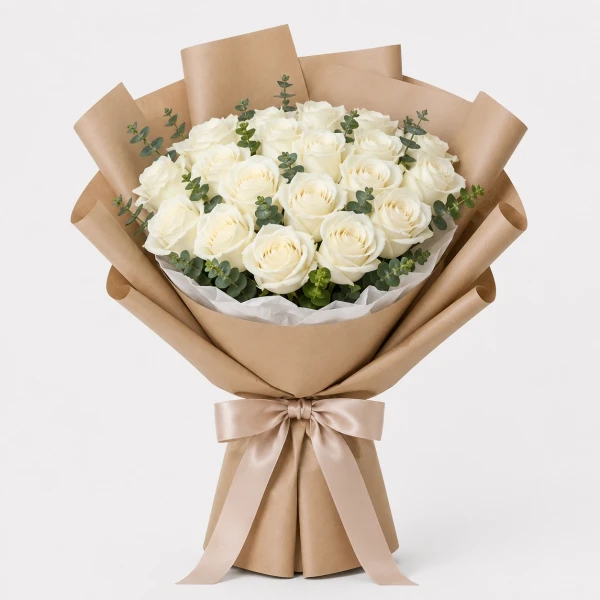 A bouquet of 30 pristine white roses with eucalyptus, wrapped in light brown paper and tied with a ribbon.