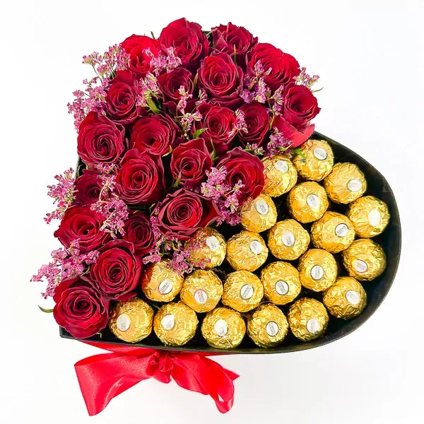 Heart-shaped box with red roses and Ferrero Rocher chocolates.