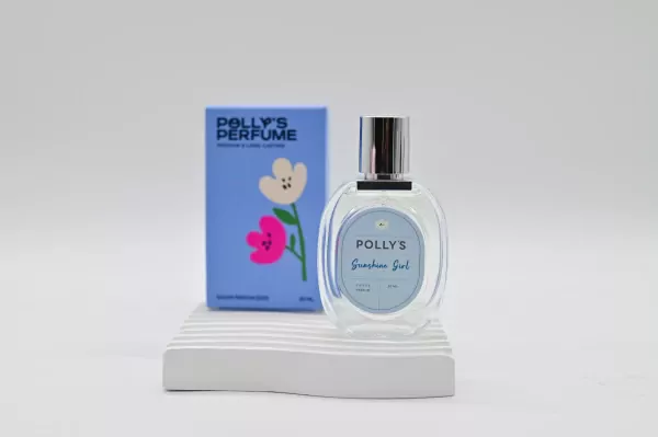 Polly's Sunshine Girl perfume bottle and box on a white stand, featuring floral designs.