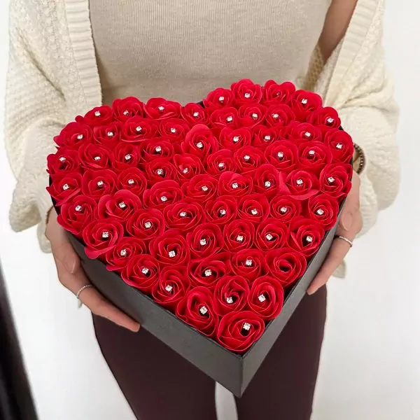 Heart-shaped box filled with red roses, each with a diamond accent.
