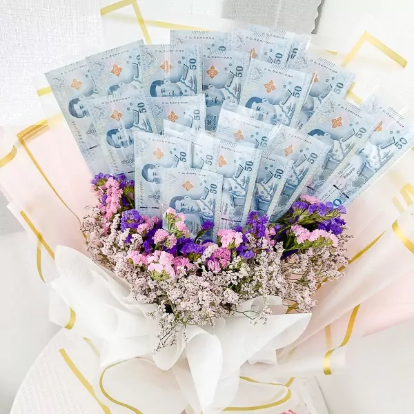 Bouquet of dried flowers with placeholders for 50 Thai Baht banknotes, tied with a white ribbon.