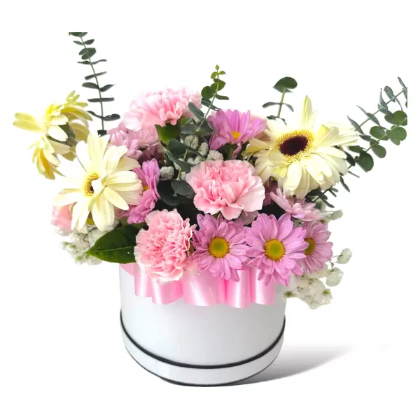 Pink and white flowers with eucalyptus in a white hatbox, adorned with a pink ribbon.