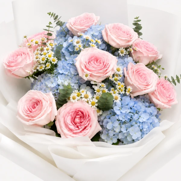 Pink roses and blue hydrangeas bouquet with white wrapping and ribbon.