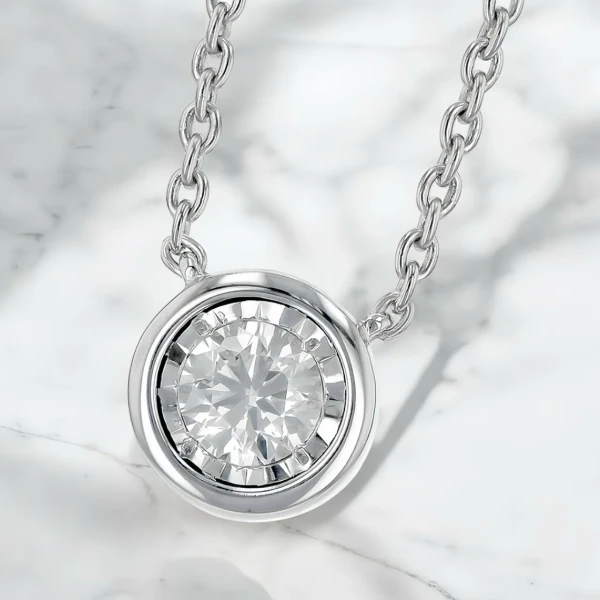 Solitaire moissanite diamond pendant necklace with a white gold chain.