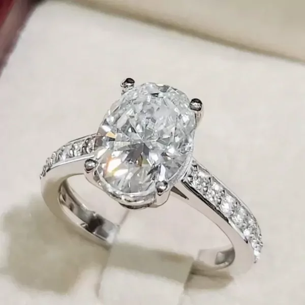 Oval-cut moissanite diamond ring with a white gold plated sterling silver band.