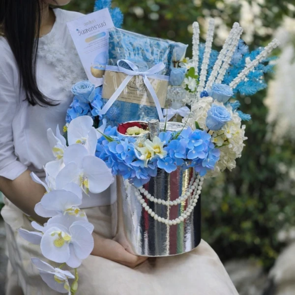 Blue Songkran gift basket with scarf, flowers, and pearls.