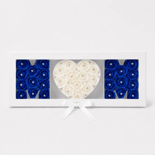 "Mom" spelled with blue and white roses with diamond centers in a white gift box.