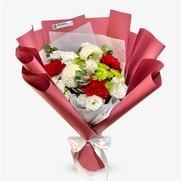 A bouquet of red, white, and green flowers wrapped in pink paper, tied with a white ribbon.