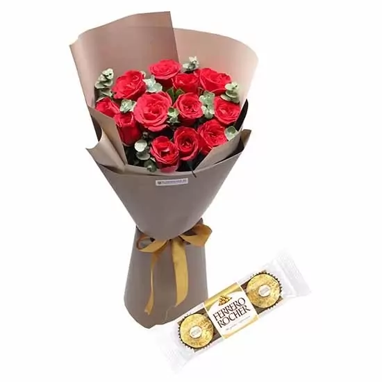 Bouquet of 12 red roses with eucalyptus, wrapped in brown paper with a gold ribbon, and two Ferrero Rocher chocolates.