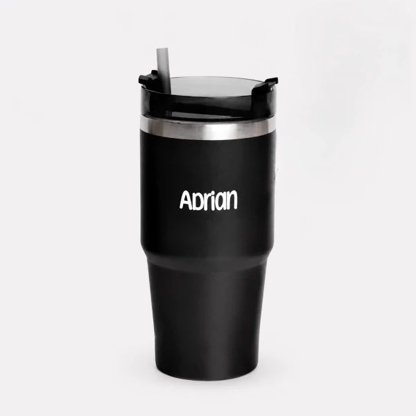Black personalized tumbler with "Adrian" etched on it and a straw.