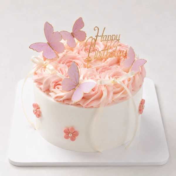 Pink rose bouquet and mini cake with butterfly decorations.