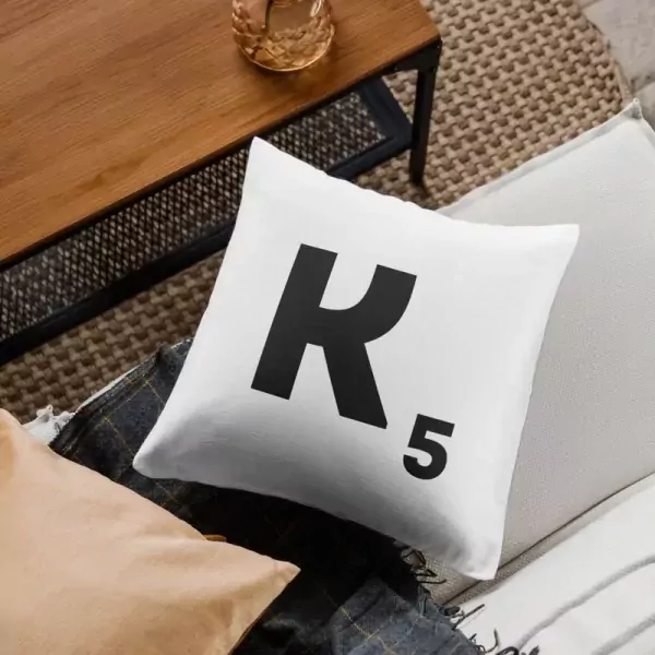 White throw pillow with black "K" and "5" in Scrabble tile design.