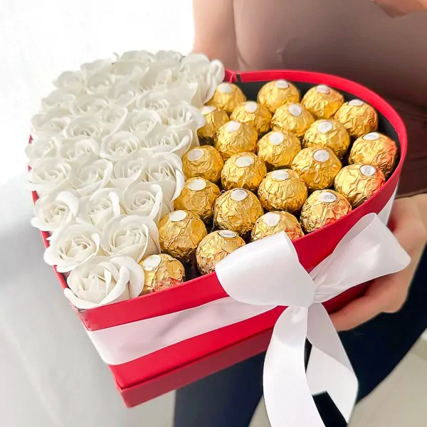 Heart-shaped red box with white roses and Ferrero Rocher chocolates.