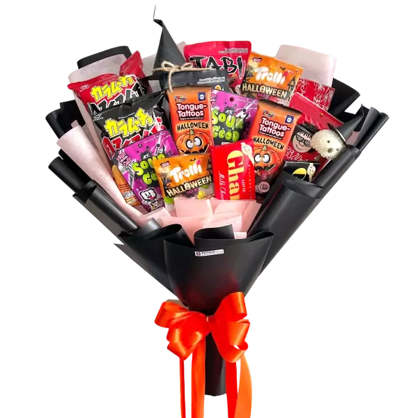Halloween snack bouquet with treats, wrapped in black paper and tied with orange ribbons.