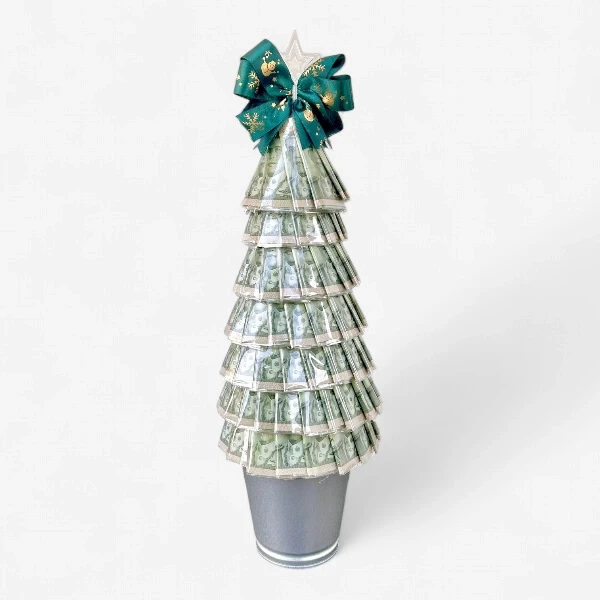 Christmas money tree made of folded Thai baht banknotes, topped with a star and green bow.