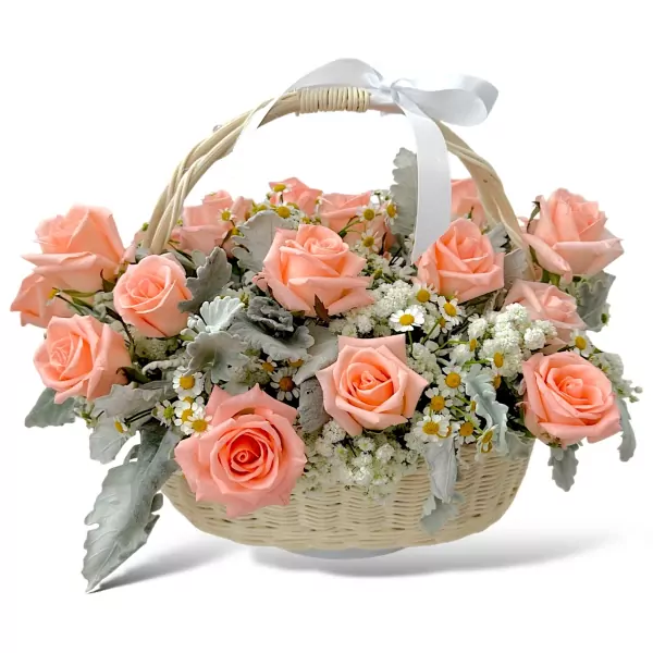 A woven basket filled with pastel pink roses, baby's breath, and dusty miller, tied with a white ribbon.