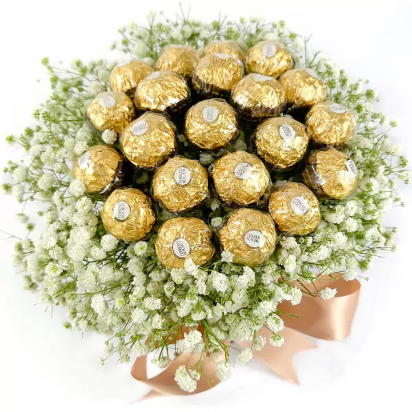 Ferrero Rocher chocolates and white gypsophila flowers arranged in a bouquet, tied with a ribbon.