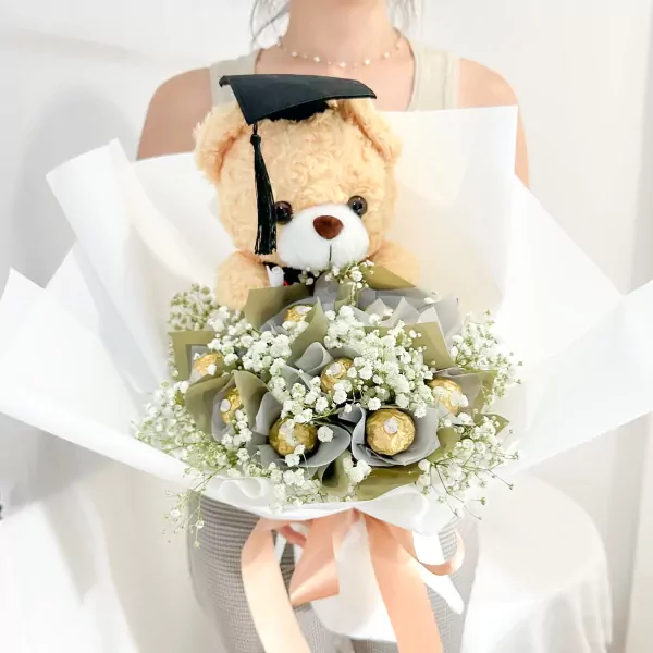 Graduation bouquet with teddy bear, Ferrero Rocher chocolates, and white gypsophila.