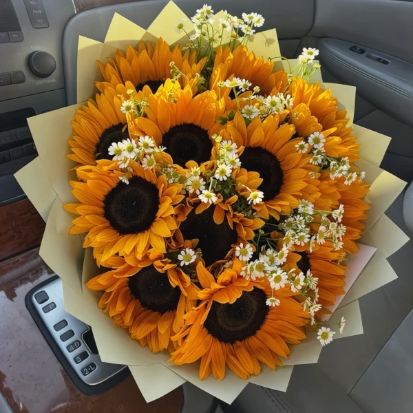 Bouquet of 20 sunflowers and daisies in a car.