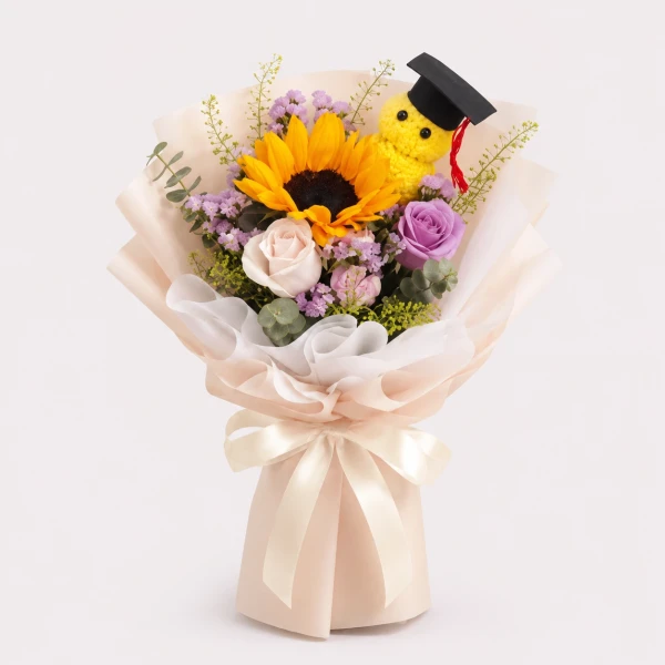 Graduation bouquet with sunflower, roses, teddy bear graduation cap, and ribbon.