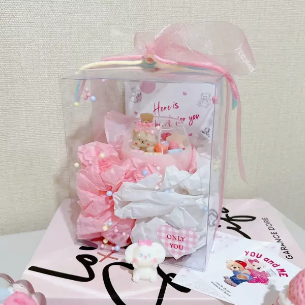 Candle gift box with tiny bear-shaped candles and pink tissue paper.