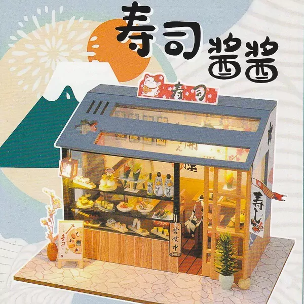 Miniature sushi restaurant model with display cases full of sushi and interior seating.