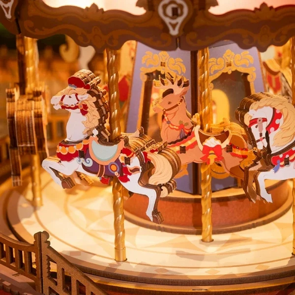 A wooden carousel with painted horses, deer, and ornate details.
