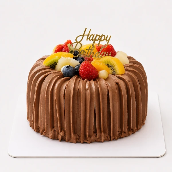 Round chocolate cake with chocolate frosting, topped with mixed fruits and a "Happy Birthday" topper.