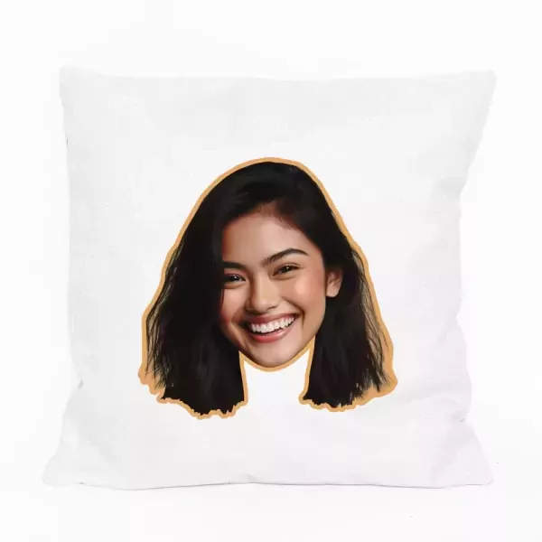 White pillow with a cutout of a smiling young woman's face printed on it.