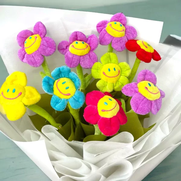 Plush flower bouquet with smiling smiley faces in bright colors.