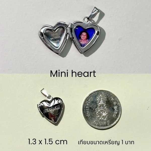 Heart-shaped locket necklace with photo and Thai coin for scale.