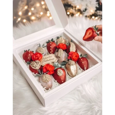 Chocolate-dipped strawberries and red roses in a white gift box with "Happy Birthday" topper.