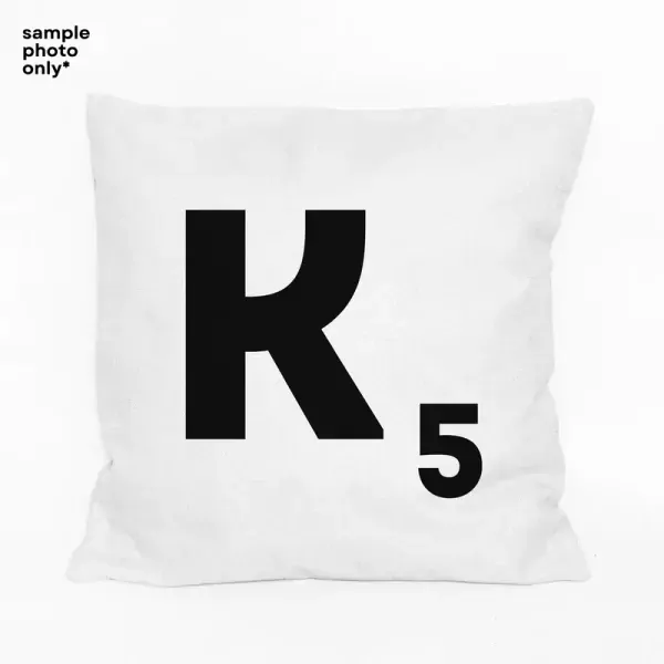 White pillow with black Scrabble letter K and number 5 tile design.