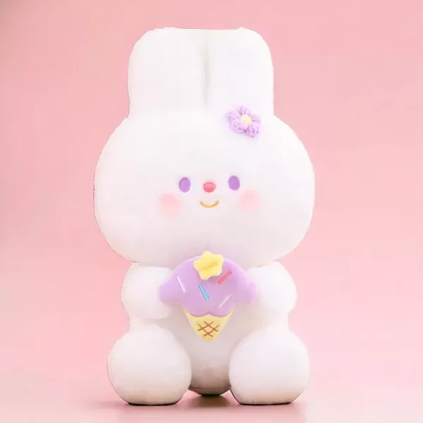 Cute white rabbit plushie holding a purple ice cream cone with a flower on its head.