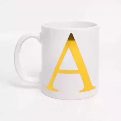 White ceramic mug with a large, bold, gold letter "A" on the side.