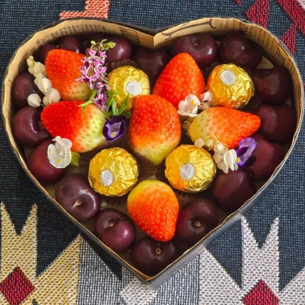 Heart-shaped box filled with strawberries, cherries, and Ferrero Rocher chocolates.