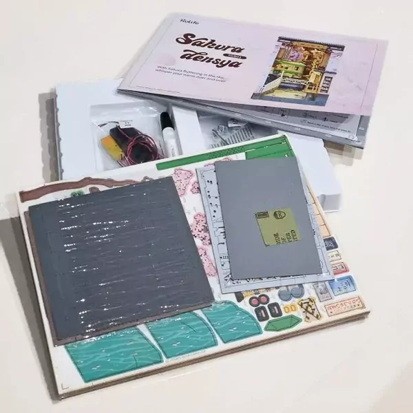 DIY Book Divider kit laid out, showing wooden pieces, instructions, and assembly components.