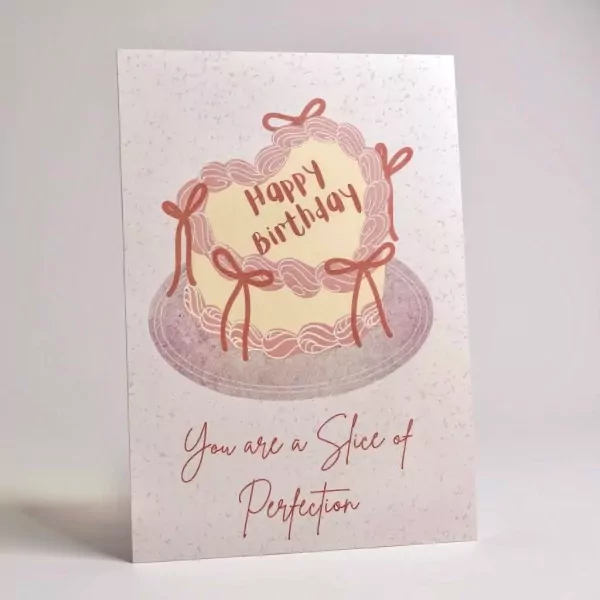 Birthday card with a heart-shaped cake saying "Happy Birthday" and "You are a slice of perfection."