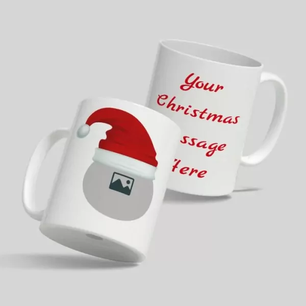 Two white mugs with a Christmas theme. One mug has "Your Christmas message here" in red text, the other has a Christmas hat and a placeholder image.