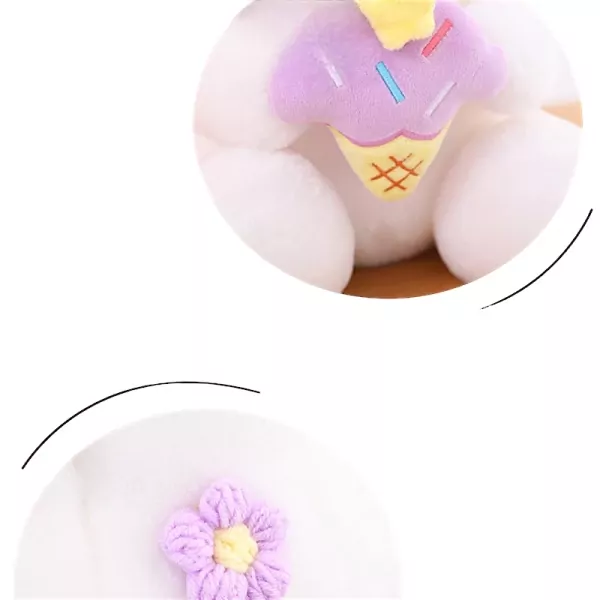 White plush rabbit wearing a purple ice cream cone hat, with a purple crocheted flower on its chest.