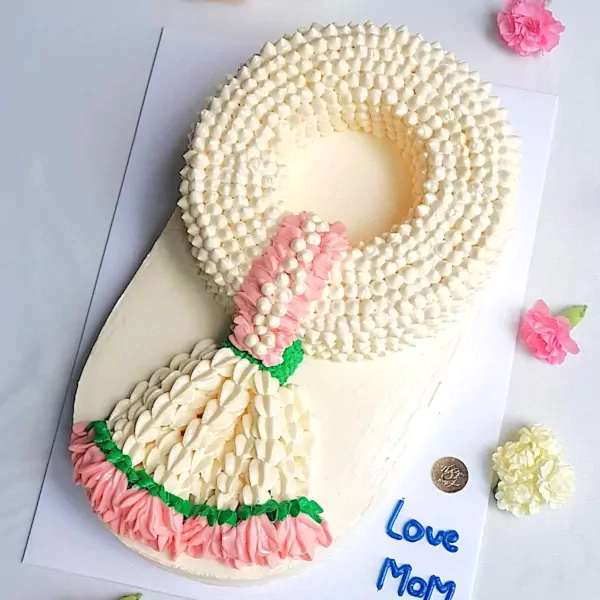 A cake decorated to look like a jasmine garland, with pink and white frosting.