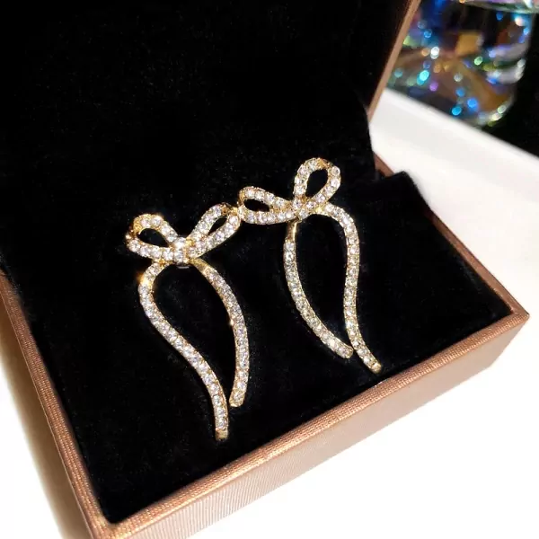 Sparkling silver ribbon earrings with cubic zirconia in a gift box.