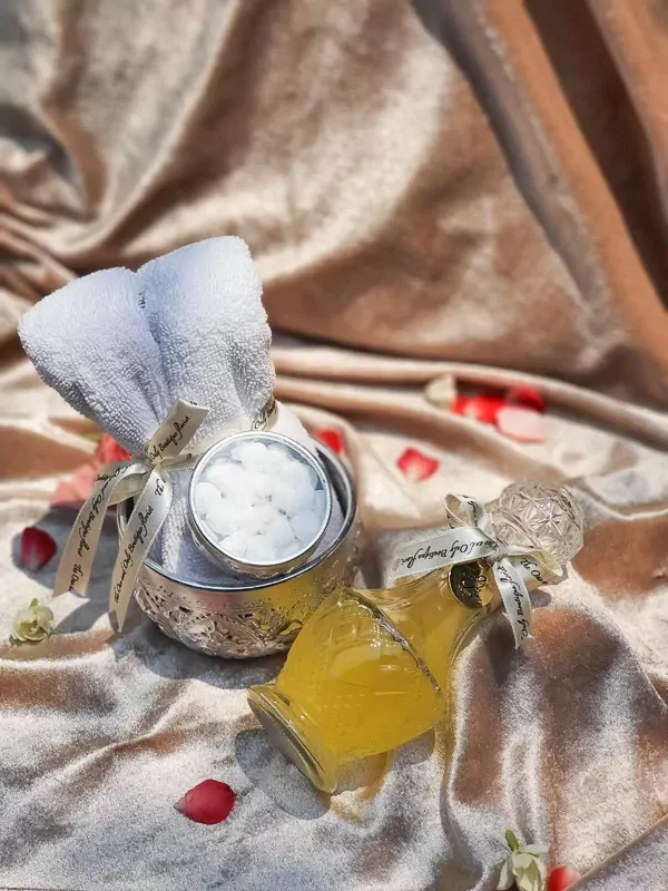 Thai Water Ceremony Set S with essence water bottle and white towel on satin cloth.